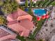 The large house shows the amazing backyard with a sparkling pool, a spacious patio, and lush landscaping at 1705 Corta Bella Dr, Las Vegas, NV 89134