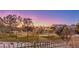 Community view of homes and golf course at sunset at 1705 Corta Bella Dr, Las Vegas, NV 89134