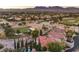 Aerial view of a community with well-manicured golf courses and stunning mountain views in the background at 1705 Corta Bella Dr, Las Vegas, NV 89134