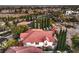 Expansive view of a neighborhood showcasing a beautiful home with a red tile roof and lush landscaping at 1705 Corta Bella Dr, Las Vegas, NV 89134