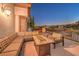 A spacious balcony offers comfortable seating and a beautiful view of the surrounding area at twilight at 1705 Corta Bella Dr, Las Vegas, NV 89134