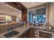 Wet bar featuring a sink, granite countertops, beverage storage, and an adjacent outdoor view at 1705 Corta Bella Dr, Las Vegas, NV 89134