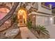 Inviting entryway with a brick facade and lush landscaping at 1705 Corta Bella Dr, Las Vegas, NV 89134