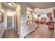 The foyer shows a staircase leading to the upper level, with hardwood flooring and arched windows for natural light at 1705 Corta Bella Dr, Las Vegas, NV 89134