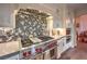 Gourmet kitchen with stainless steel appliances and unique hexagonal backsplash at 1705 Corta Bella Dr, Las Vegas, NV 89134