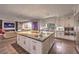 A modern kitchen features an oversized island with marble countertops, stainless steel appliances and ample counter space at 1705 Corta Bella Dr, Las Vegas, NV 89134