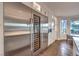 Modern kitchen with built-in wine cooler and stainless steel appliances at 1705 Corta Bella Dr, Las Vegas, NV 89134