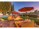 Relaxing patio features fire pit, seating, and umbrellas at 1705 Corta Bella Dr, Las Vegas, NV 89134