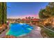 Stunning pool and spa at dusk with mountain views at 1705 Corta Bella Dr, Las Vegas, NV 89134