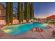 Inviting pool with rock features, and landscape lighting at 1705 Corta Bella Dr, Las Vegas, NV 89134