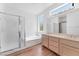 Bathroom with light wood cabinets, a soaking tub and shower at 1717 Warrington Dr, Henderson, NV 89052