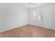 Simple bedroom with wood floors and window at 1717 Warrington Dr, Henderson, NV 89052