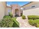 Inviting entryway with a paved walkway, landscaping, and arch at 1717 Warrington Dr, Henderson, NV 89052