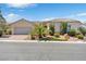 House exterior with palm trees, landscaping, and a paved driveway at 1717 Warrington Dr, Henderson, NV 89052