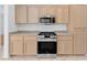 Stainless steel appliances and light wood cabinets in this kitchen at 1717 Warrington Dr, Henderson, NV 89052