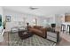 Virtually staged living room featuring a brown sofa and neutral decor at 1717 Warrington Dr, Henderson, NV 89052