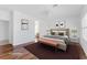 Virtually staged main bedroom with hardwood floors and neutral decor at 1717 Warrington Dr, Henderson, NV 89052