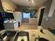 View of a kitchen with white appliances and a double sink at 1925 E Saint Louis Ave, Las Vegas, NV 89104