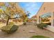 Landscaped backyard with mature trees and gravel at 2000 Poppywood Ave, Henderson, NV 89012