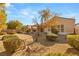 Landscaped backyard with mature trees and shrubs at 2000 Poppywood Ave, Henderson, NV 89012