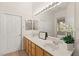 Double vanity bathroom with large mirror and view to backyard at 2000 Poppywood Ave, Henderson, NV 89012