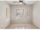 Bedroom with plantation shutters, ceiling fan and large window at 2000 Poppywood Ave, Henderson, NV 89012