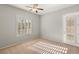 Bedroom with plantation shutters, ceiling fan, and door to patio at 2000 Poppywood Ave, Henderson, NV 89012