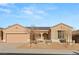 Tan colored house with solar panels, landscaping, and a two-car garage at 2000 Poppywood Ave, Henderson, NV 89012