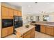 Spacious kitchen with wood cabinets, granite counters, and stainless steel appliances at 2000 Poppywood Ave, Henderson, NV 89012