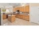 Kitchen with wood cabinets, granite countertops, island, and stainless steel appliances at 2000 Poppywood Ave, Henderson, NV 89012