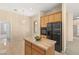 Kitchen with wood cabinets, granite countertops, island, and stainless steel appliances at 2000 Poppywood Ave, Henderson, NV 89012