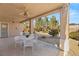 Covered patio with seating area and desert landscaping at 2000 Poppywood Ave, Henderson, NV 89012