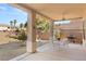 Covered patio with table and chairs, overlooking backyard at 2000 Poppywood Ave, Henderson, NV 89012