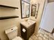 Bathroom with single sink vanity, toilet, and large mirror at 2253 High Dunes Ln, Laughlin, NV 89029