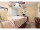 Main bedroom with a large bed, ceiling fan, and a small wooden table at 2254 High Dunes Ln, Laughlin, NV 89029