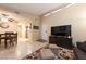 Bright living room featuring tile floors and a large TV at 2254 High Dunes Ln, Laughlin, NV 89029