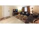 Living room featuring two brown sofas, a floral rug, and a large TV at 2254 High Dunes Ln, Laughlin, NV 89029