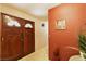 Interior entryway with wood double doors and terracotta-colored walls at 2816 Mohawk St, Las Vegas, NV 89146