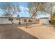 Spacious backyard with covered patio, mature trees, and storage shed at 2824 Bassler St, North Las Vegas, NV 89030