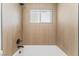 Bathroom with wood-look walls and a large bathtub at 2824 Bassler St, North Las Vegas, NV 89030