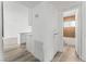 Bright hallway with light wood floors and a view of the kitchen and bathroom at 2824 Bassler St, North Las Vegas, NV 89030