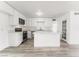 Modern kitchen featuring white cabinets, quartz countertops, and stainless steel appliances at 2824 Bassler St, North Las Vegas, NV 89030