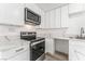 Stainless steel appliances and white shaker cabinets highlight this kitchen at 2824 Bassler St, North Las Vegas, NV 89030