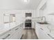 Bright white kitchen with stainless steel appliances and an island at 2824 Bassler St, North Las Vegas, NV 89030