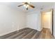 Well-lit bedroom with mirrored closet doors and wood-look floors at 2983 Juniper Hills Blvd # 203, Las Vegas, NV 89142