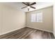 Simple bedroom with ceiling fan and wood-look flooring at 2983 Juniper Hills Blvd # 203, Las Vegas, NV 89142