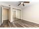 Bedroom with mirrored closet doors and wood-look floors at 2983 Juniper Hills Blvd # 203, Las Vegas, NV 89142