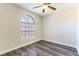 Bedroom with large arched window and laminate wood floor at 2983 Juniper Hills Blvd # 203, Las Vegas, NV 89142