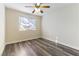 Spacious bedroom with ceiling fan and wood-look flooring at 2983 Juniper Hills Blvd # 203, Las Vegas, NV 89142