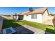 Artificial turf backyard with patio and access to house at 3123 Logan Ave, North Las Vegas, NV 89032